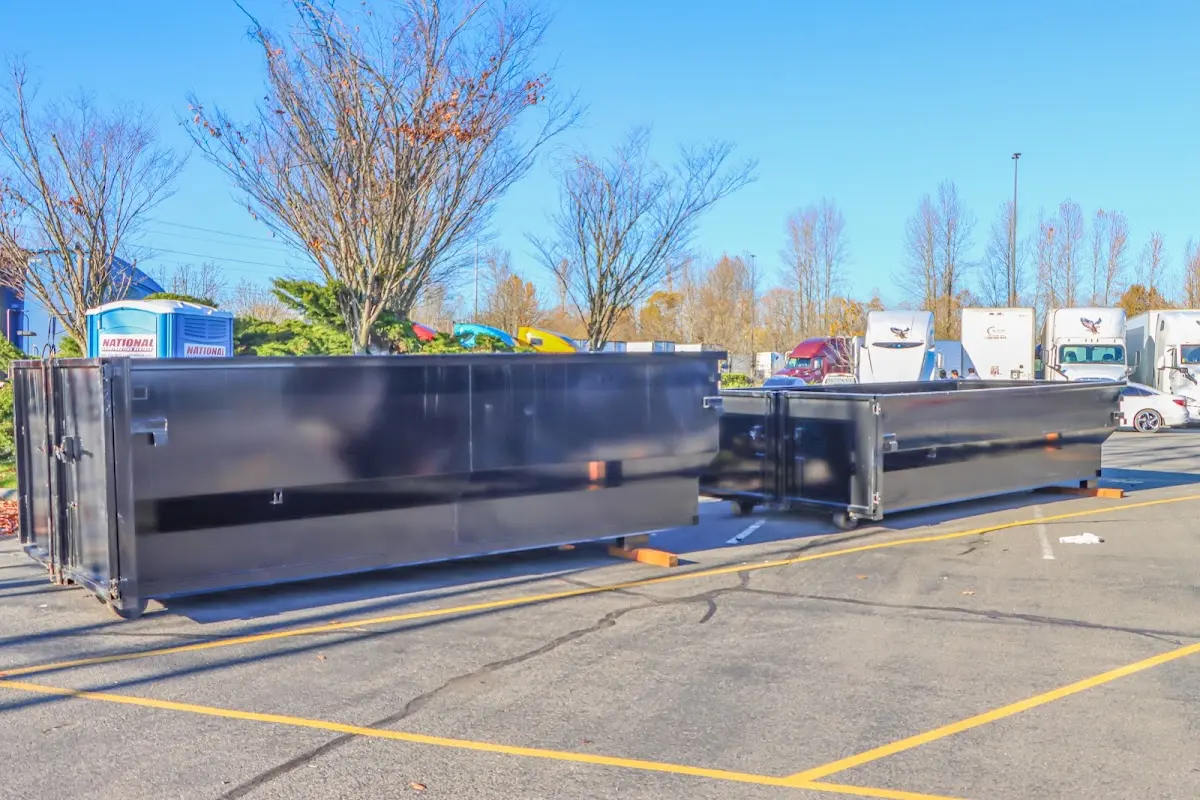 Professional dumpster rental service with roll-off container on residential driveway in Murray